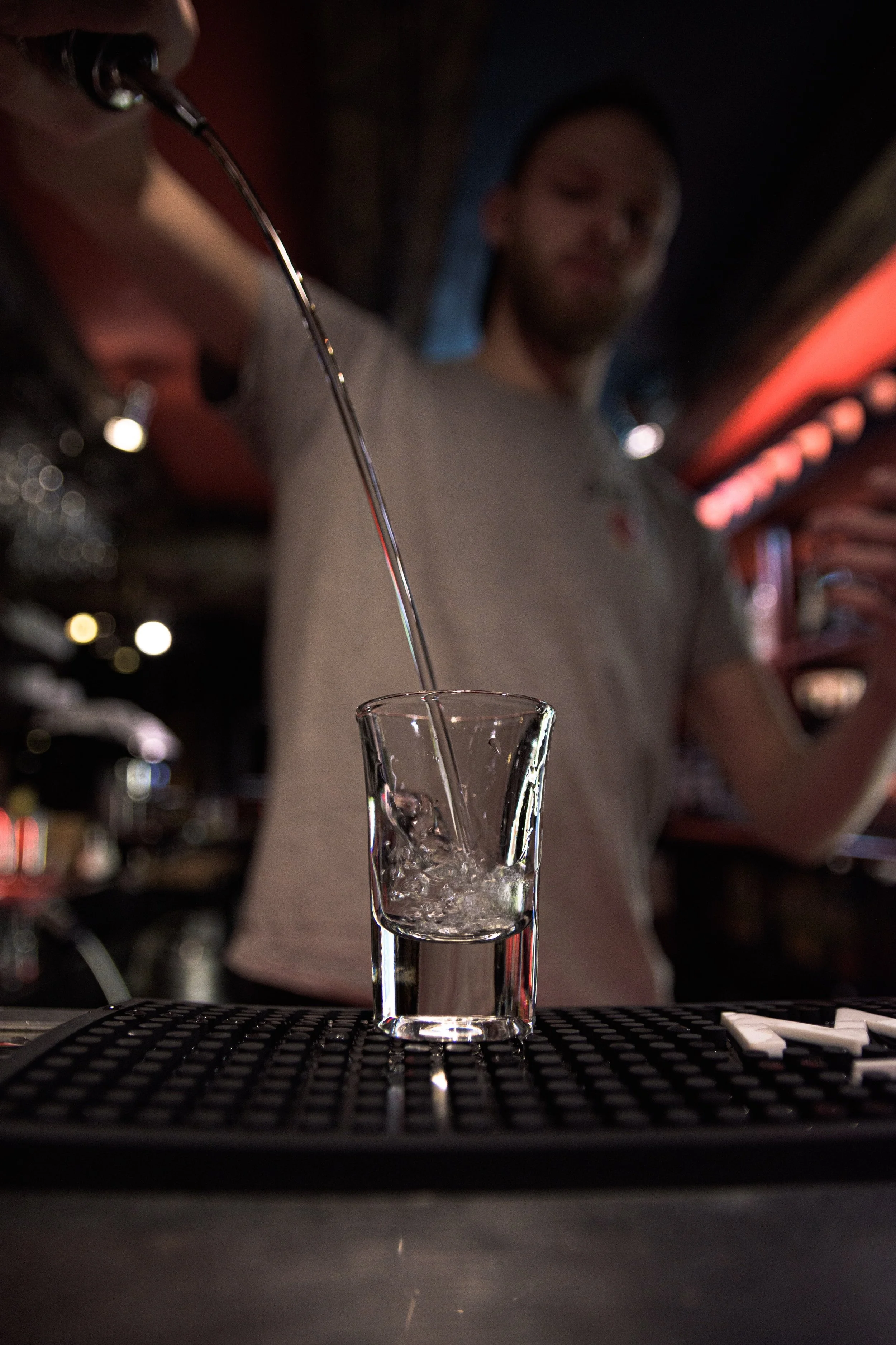 Bartender pouring a drink at The Anvil
